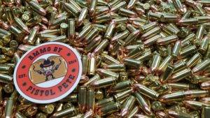 Loose remanufactured pistol ammo pile with a sticker that says Ammo by Pistol Pete and has a character holding two guns in the air.
