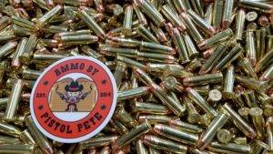 Loose remanufactured pistol ammo pile with a sticker that says Ammo by Pistol Pete and has a character holding two guns in the air.