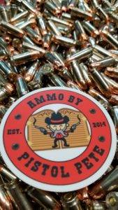 Loose remanufactured pistol ammo pile with a sticker that says Ammo by Pistol Pete and has a character holding two guns in the air.