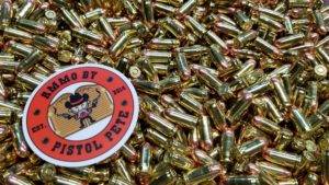 Loose remanufactured pistol ammo pile with a sticker that says Ammo by Pistol Pete and has a character holding two guns in the air.