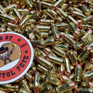 Loose remanufactured pistol ammo pile with a sticker that says Ammo by Pistol Pete and has a character holding two guns in the air.