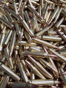 Loose remanufactured rifle ammo pile.