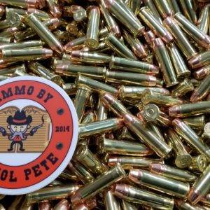 Loose remanufactured pistol ammo pile with a sticker that says Ammo by Pistol Pete and has a character holding two guns in the air.