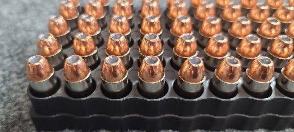 10mm 180 gr. XTP Hollow Point bulk remanufactured pistol ammo sitting in ammo trays point up.