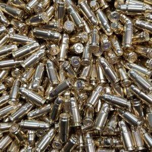 Loose 357 sig ammo in a pile with shiny clean brass.