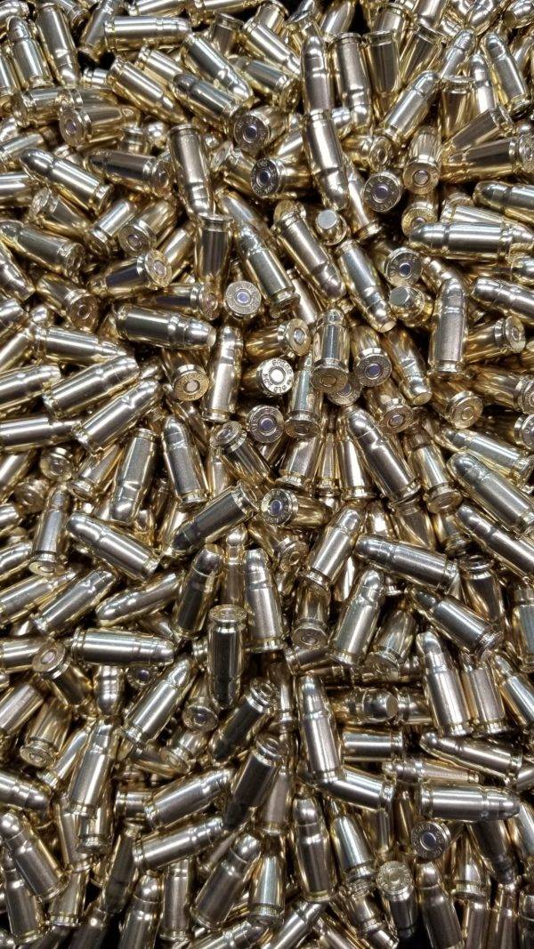 Loose 357 sig ammo in a pile with shiny clean brass.
