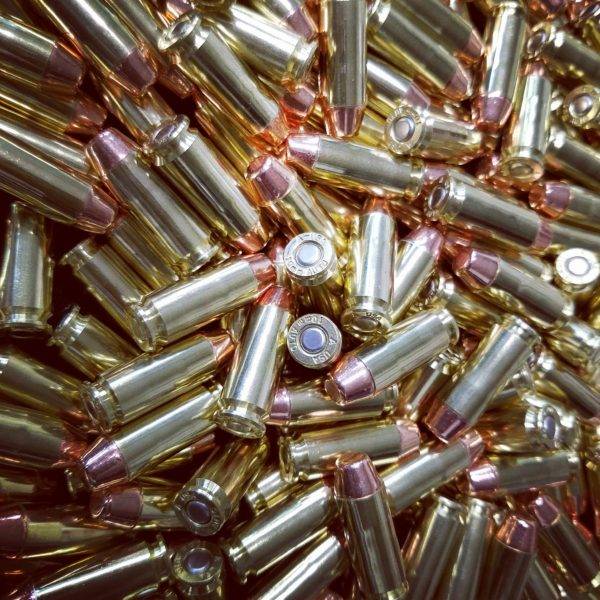 Loose .40 S&W ammo in a pile with shiny clean brass.