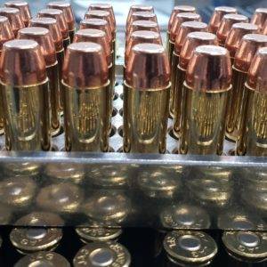 45 long colt Pistol ammo in a inside of an ammo trays with the points facing up.