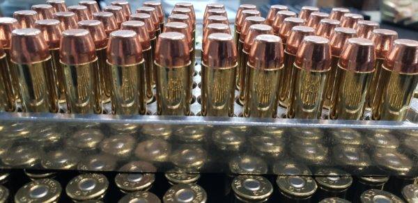45 long colt Pistol ammo in a inside of an ammo trays with the points facing up.