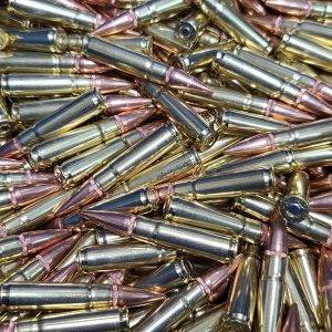 300 Blackout bulk remanufactured ammunition for rifles shining in a large loose pile.