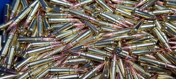 300 Blackout bulk remanufactured ammunition for rifles shining in a large loose pile.